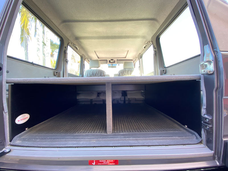 G-wagen W463 storage shelf cargo storage platform extra cargo space sleeping platform showing space below platform grey carpet