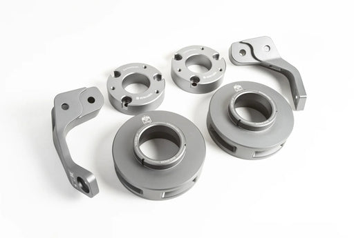 2 1/2-inch Lift Kit components for 2019+ Mercedes G-Class laid out on a white background showing grey anodized aluminum spacers and control arms