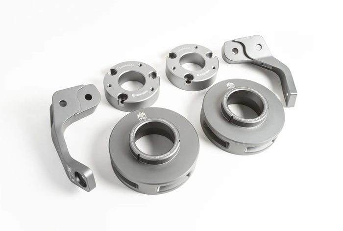 2 1/2-inch Lift Kit components for 2019+ Mercedes G-Class laid out on a white background showing grey anodized aluminum spacers and control arms